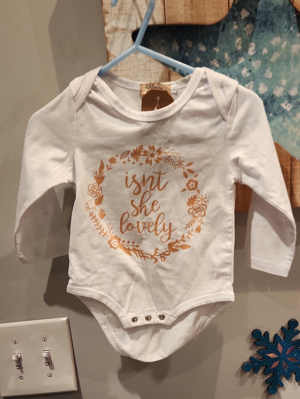 White Long-Sleeve Baby Bodysuit with Gold Floral Script